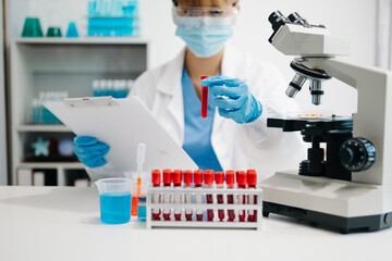 Female scientist researcher conducting an experiment working in the laboratory