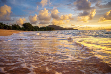 A beautiful wild beach, the waves of the clear sea roll on the white sand. evening sea.