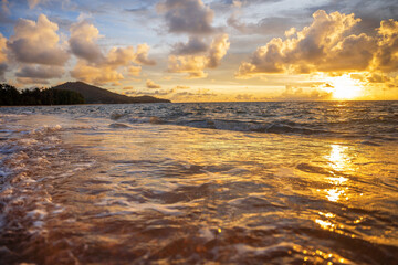 A beautiful wild beach, the waves of the clear sea roll on the white sand. evening sea.