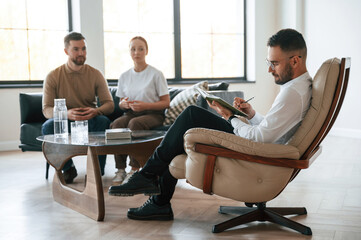 Sitting and talking. Couple at a psychologist's appointment