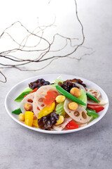 traditional chinese fresh vegetable wok stir fried mixed veggies bean curd lotus root soya sauce in clay pot on grey vintage background asian cafe hotel luxury halal vegan food restaurant banquet menu