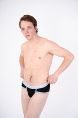 Fototapeta premium A young attractive guy posing in the studio.