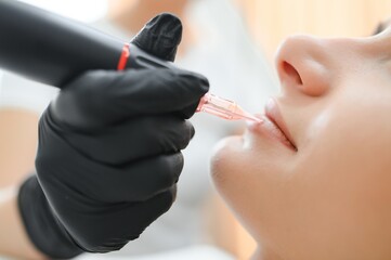 Banner Process woman applying permanent tattoo makeup on lips in beautician salon