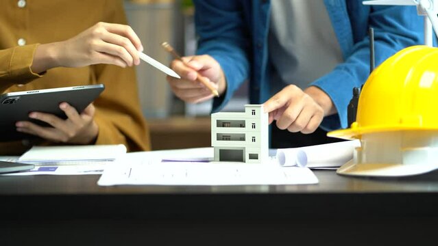 Engineer Teamwork, Drawing working on blueprint meeting for project working with partner on model building at company office.