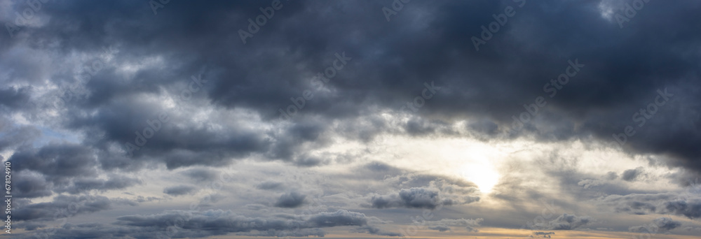 Wall mural panoramic cloudscape with dark moody atmospheric clouds