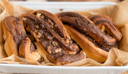 Freshly baked Chocolate babka. Sweet bread or twisted chocolate brioche, wooden background, close-up