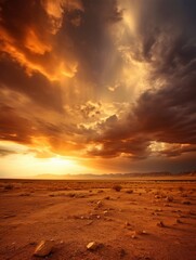 Fototapeta na wymiar Golden sundown in the desert with lots of sun rays in the dramatic sky