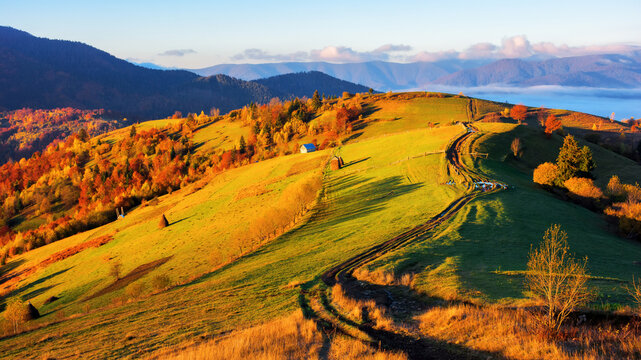 mountainous rural landscape at sunrise. autumnal countryside scenery in morning light