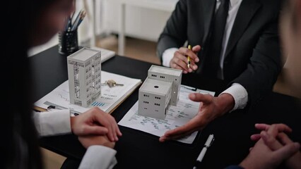 Business people selling, buying or mortgage and signing agreement paperwork for loan financial to buying apartment house properties.