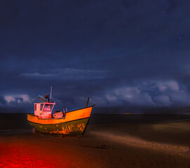Naklejka na ściany i meble fishing boat on the beach at night