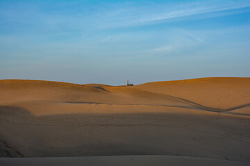 Fototapeta na wymiar Sand dunes of Maspalomas with lighthouse on Gran Canaria, Spain