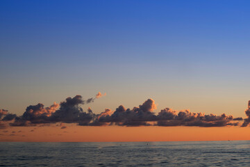 Photographic shot of clouds over the sea at sunset