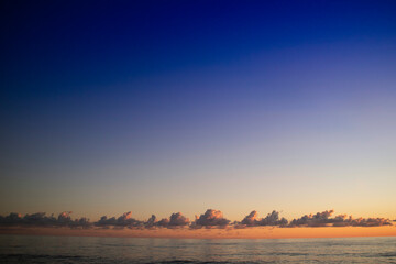 Photographic shot of clouds over the sea at sunset