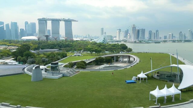 Aerial of Marina Barrage, an impressive engineering marvel and a vital part of Singapore's sustainable development, revealing city skyline on horizon.