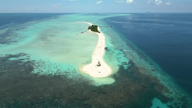 Aerial view captures the beauty of Sabah's Pulau Timba Timba island, located in Malaysia. Tropical paradise, crystal-clear waters surround island's shores, pristine sandy beaches and lush greenery.