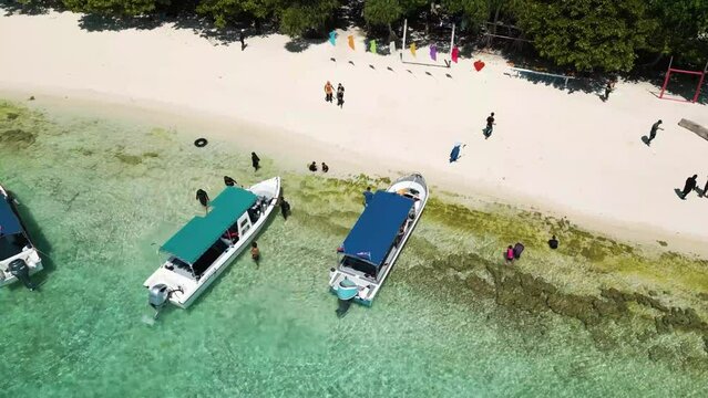Aerial of beach with touristic boats docked, location island hopping in Sabah, Malaysia, destination unfolds a unique chapter of natural beauty and cultural richness.