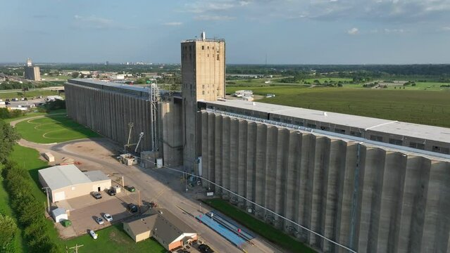 Massive concrete grain elevator towers over the flat landscape in Topeka, Kansas. Aerial shot of Cargill storage.