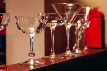 Different martini glasses in a bar in Antwerp with red light