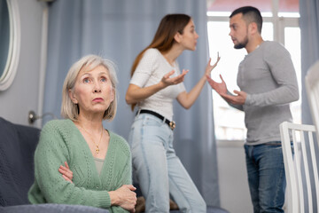 Offended elderly mother dont speaking with adult children during home quarrel - obrazy, fototapety, plakaty