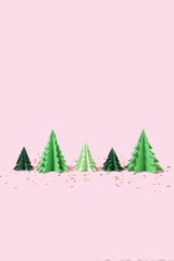 Paper Christmas trees with colorful confetti on pink background. Creative concept.
