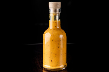 Bottle of curry sauce on a black background