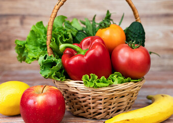 Healthy vegetables and fruits in the basket and on the table. Close-up.