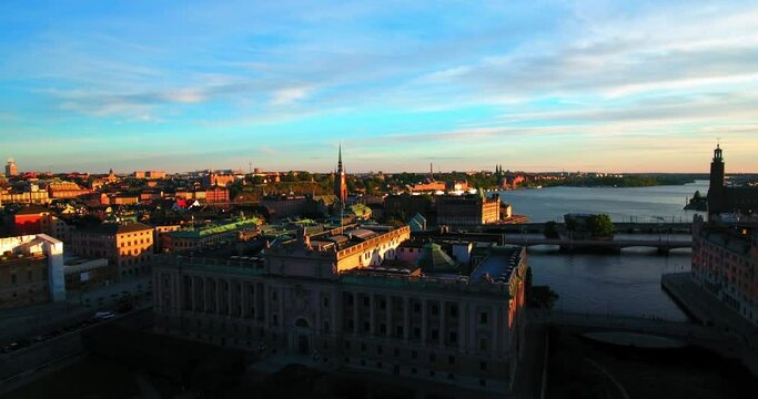 Aerial Forward Shot Of Government Buildings By River In City Against Sky - Stockholm, Sweden