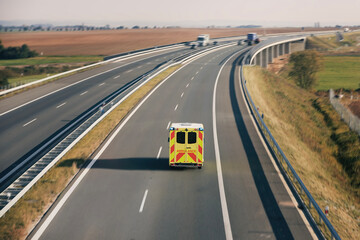 Fast moving ambulance car of emergency medical service on highway. Themes health care, rescue and...