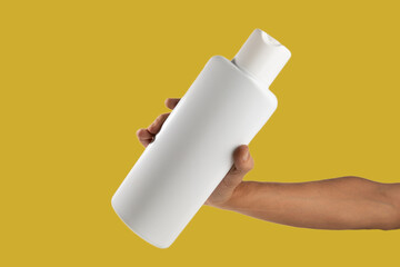 Mockup of unbranded white shampoo or conditioner bottle on yellow background