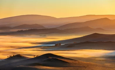 Gordijnen Beautiful mountain range and fog natural landscape at sunrise in Inner Mongolia, China. Grassland natural scenery in autumn season. © ABCDstock