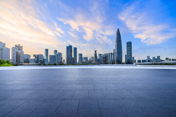 City square and skyline with modern buildings in Shenzhen at sunset, Guangdong Province, China. Empty square floor and city building background.