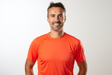 Fototapeta premium Portrait of a tender man in his 30s wearing a moisture-wicking running shirt against a white background. AI Generation