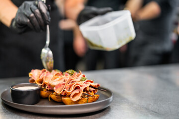 chef Cooking of beef tongue with potatoes and mushroom sauce at the restaurant kitchen