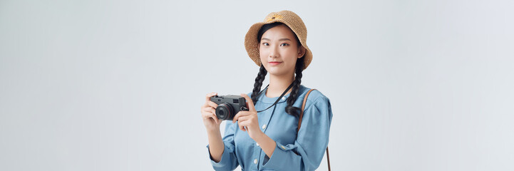 Pretty girl with old camera on a white background