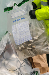 Evidence bags containing items found at a cannabis factory including high powered grow-lamps