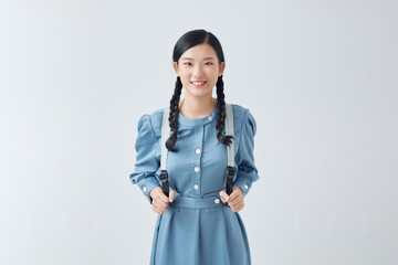 happy beautiful young woman smiling and pointing away over white background