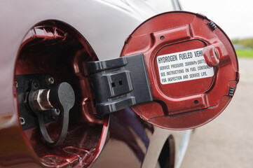 Filler cap on a car which uses hydrogen as fuel to power a fuel cell which generates electricity, which in turn powers an electric motor.