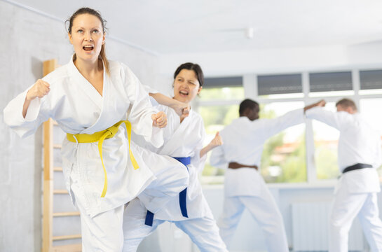 Block, then strike. Shot of two female martial artists practicing karate