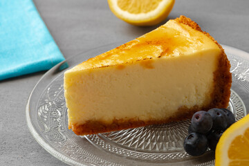 Piece of lemon cheesecake on glass dish