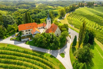 Foto op Plexiglas Aerial view of the Church and green vineyards, Jeruzalem winery region, Slovenia © Mazur Travel
