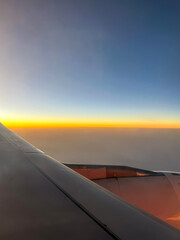 Sky high above the Clouds - Ariel View of the Sky and Sunset from the Plane 