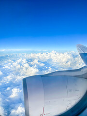 Above the Clouds - Aerial View of Blue Sky and Fluffy Clouds from the Aeroplane Window during Flight