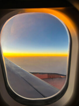 Sky high above the Clouds - Ariel View of the Sky and Sunset from the Plane Window during flight