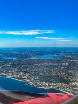 Sky high above the Clouds - Ariel View of Land and Sea from the Plane 