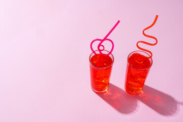 Summer drinks with straws on color background