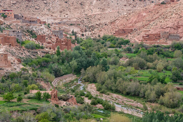 Orange mud villages on the valley of a river in the Atlas Mountains in North Africa