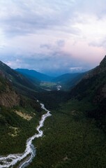 Aerial panorama of a Shdugra waterfall among the high Caucasian mountains, Mount Ushba in the background. Valley. Stormy flow of mountain river Dolra. Summer vacation, hiking in Mazeri, Georgia