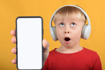 cute boy child shows smartphone with blank white screen
