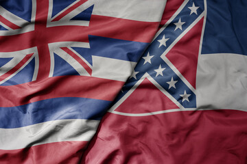 big waving colorful national flag of mississippi state and flag of hawaii state .
