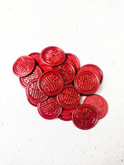 Close up shot of colorful wax coin for wedding invitation decoration or vintage look for a letter. Top view.